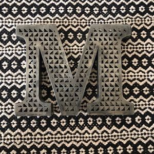 Distressed metal initial ‘M’